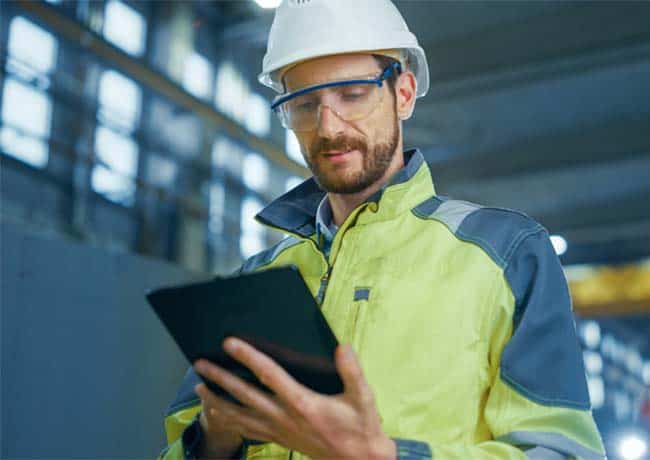 safety expert uses tablet to enter data updates