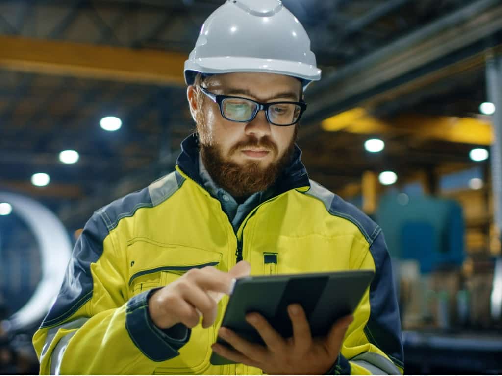 technician uses a tablet to perform maintenance checks